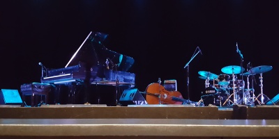 Stage with piano, upright bass, & drumset before the performers arrived onstage